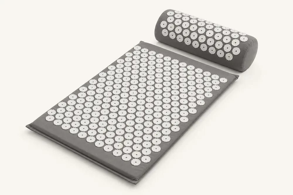 SpikeRest acupressure mat and bolster pillow set in Gray on a plain backdrop