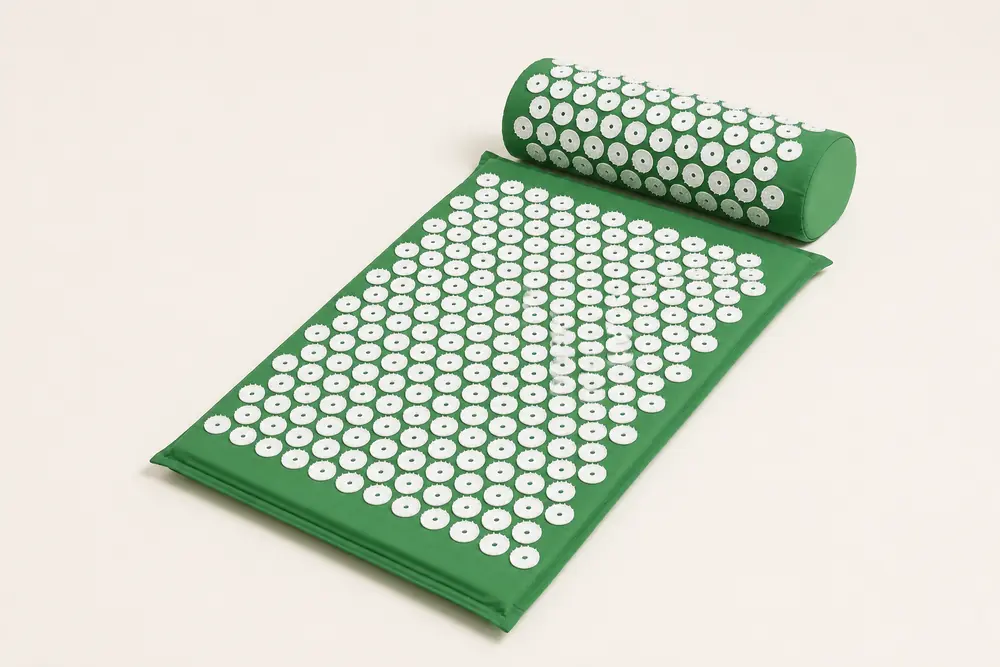 SpikeRest acupressure mat and bolster pillow set in Green on a plain backdrop