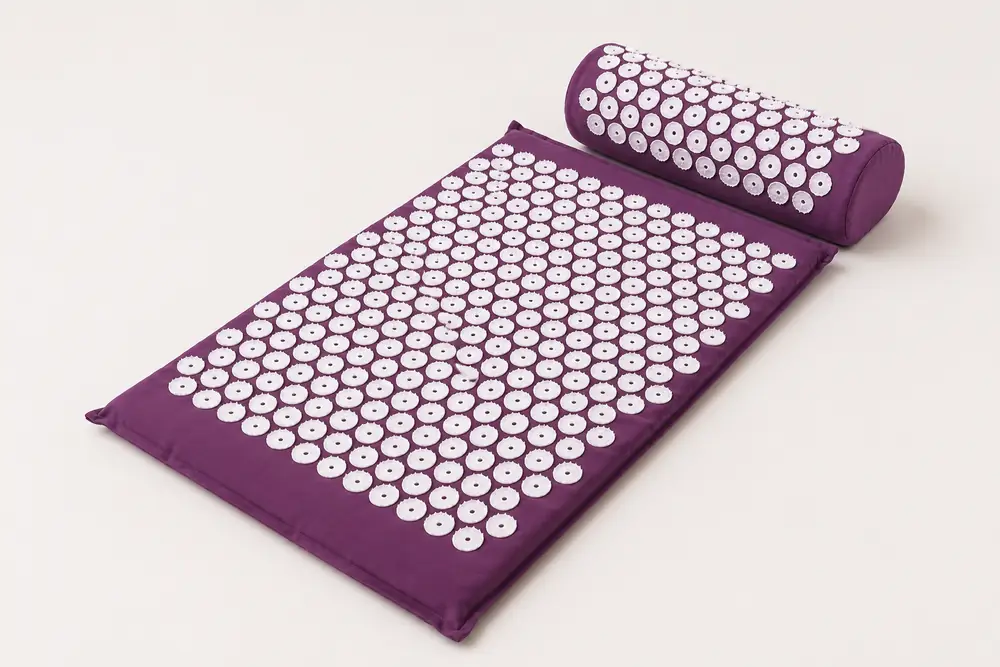 SpikeRest acupressure mat and bolster pillow set in Purple on a plain backdrop